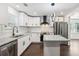 Updated kitchen features stainless appliances, granite countertops, and sleek white cabinets at 7540 Conyers St, Lithonia, GA 30058