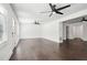 Open living room with dark wood floors and many windows at 7540 Conyers St, Lithonia, GA 30058