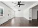 Bright living room with many windows and ceiling fan at 7540 Conyers St, Lithonia, GA 30058