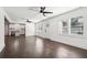 Open floor plan living room and kitchen with hardwood flooring and white walls at 7540 Conyers St, Lithonia, GA 30058