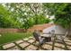 Lush backyard showcasing a fire pit area, privacy fence, and mature trees, creating a private and inviting outdoor oasis at 82 Dearborn Se St, Atlanta, GA 30317