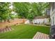 Serene backyard features a well-manicured lawn, a cozy fire pit area, and privacy fencing, ideal for relaxation and entertainment at 82 Dearborn Se St, Atlanta, GA 30317