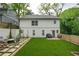 Beautiful backyard with artificial grass, a seating area, and a grill perfect for outdoor entertaining at 82 Dearborn Se St, Atlanta, GA 30317