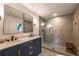 Modern bathroom features a double vanity with brass accents and a spacious walk-in shower with gray tiling and black fixtures at 82 Dearborn Se St, Atlanta, GA 30317