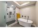 Bright bathroom with a glass-enclosed shower, a freestanding tub, and modern fixtures at 82 Dearborn Se St, Atlanta, GA 30317