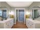 Stylish bathroom with dual vanities, round mirrors, modern fixtures, and a glimpse into a separate shower area with dinosaur curtain at 82 Dearborn Se St, Atlanta, GA 30317