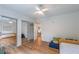 This bedroom features hardwood floors, a ceiling fan, and a mirrored closet, creating ample storage space and natural light at 82 Dearborn Se St, Atlanta, GA 30317