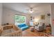 Inviting Bedroom with a crib, comfortable seating, and a window that offers a serene view, creating a warm and cozy space at 82 Dearborn Se St, Atlanta, GA 30317