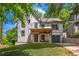 Charming two-story home with a stone facade, covered porch, and attached garage on a lush, green lot at 82 Dearborn Se St, Atlanta, GA 30317