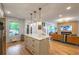 Open-concept living area with a stylish kitchen island and wood-paneled fireplace wall at 82 Dearborn Se St, Atlanta, GA 30317