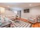 Basement living room featuring a sectional sofa, area rug, and mounted TV at 102 Woodsfield Ln, Hiram, GA 30141