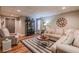 Basement living room featuring a sectional sofa, area rug, and an accent cabinet at 102 Woodsfield Ln, Hiram, GA 30141