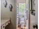 Cozy bathroom with a toilet by a window, complete with modern decor and flooring at 102 Woodsfield Ln, Hiram, GA 30141