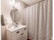 Bathroom featuring a white vanity, updated faucet, patterned shower curtain, and modern lighting at 102 Woodsfield Ln, Hiram, GA 30141