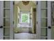 Bathroom featuring a garden tub framed by glass doors, white trim, and modern fixtures at 102 Woodsfield Ln, Hiram, GA 30141