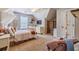 Bright bedroom with neutral tones, a comfortable bed, and a cozy reading nook at 102 Woodsfield Ln, Hiram, GA 30141