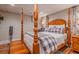 Comfortable bedroom with four-poster bed, soft duvet, and warm natural light at 102 Woodsfield Ln, Hiram, GA 30141