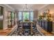 Formal dining room with modern chandelier, large windows, and stylish decor at 102 Woodsfield Ln, Hiram, GA 30141