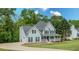 Charming two-story home featuring a welcoming front porch and lush landscaping at 102 Woodsfield Ln, Hiram, GA 30141