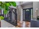 Elegant foyer featuring dark trim staircase, wood floors and a front door with sidelights at 102 Woodsfield Ln, Hiram, GA 30141