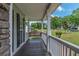 Inviting covered front porch with wooden swing, perfect for enjoying the outdoors at 102 Woodsfield Ln, Hiram, GA 30141