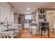 Cozy kitchenette with white cabinets, stainless steel appliances, and breakfast nook at 102 Woodsfield Ln, Hiram, GA 30141