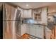 Bright kitchenette featuring stainless steel refrigerator, window, and white cabinetry at 102 Woodsfield Ln, Hiram, GA 30141