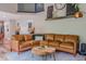Comfortable living room with a large leather sectional couch, stylish decor, and open layout design at 102 Woodsfield Ln, Hiram, GA 30141