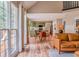 Open-concept space with a comfortable leather couch, dining area, and modern kitchen with green cabinets at 102 Woodsfield Ln, Hiram, GA 30141