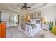 Spacious main bedroom with tray ceilings, plush bedding, and adjoining bathroom at 102 Woodsfield Ln, Hiram, GA 30141