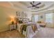 Comfortable main bedroom featuring a bed with throw pillows, a fan, and large bright windows at 102 Woodsfield Ln, Hiram, GA 30141