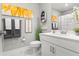 Clean and modern bathroom with white fixtures, a sunflower art piece, and stylish decor creating a relaxing atmosphere at 1700 Prospect Way, Conyers, GA 30094