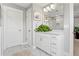 Bright bathroom featuring a glass-enclosed shower with marble-like tile and a white vanity with quartz countertop at 1700 Prospect Way, Conyers, GA 30094