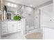 Bright bathroom featuring a glass-enclosed shower with marble-like tile and a white double vanity with quartz countertop at 1700 Prospect Way, Conyers, GA 30094