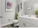 Tastefully decorated half bathroom featuring a white vanity, modern fixtures, and stylish decor at 1700 Prospect Way, Conyers, GA 30094