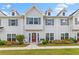 Charming townhome with gray siding, dormer windows, and a welcoming red front door with stylish landscaping at 1700 Prospect Way, Conyers, GA 30094
