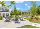 Community fire pit area with Adirondack chairs, a pergola, and a view of the surrounding landscape, ideal for gatherings at 1700 Prospect Way, Conyers, GA 30094