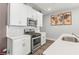 Stylish kitchen with white cabinets, stainless steel appliances, subway tile backsplash and bright quartz countertops at 1700 Prospect Way, Conyers, GA 30094