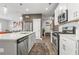 Modern kitchen features stainless steel appliances, a large island with quartz countertops, and ample cabinet space at 1700 Prospect Way, Conyers, GA 30094