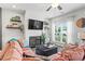 Comfortable living room featuring a fireplace, wall shelves, and a bright window at 1700 Prospect Way, Conyers, GA 30094