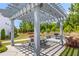 Community pergola with seating and a grill, surrounded by green trees, perfect for outdoor dining and social events at 1700 Prospect Way, Conyers, GA 30094