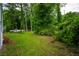 Lush backyard featuring a truck and mature trees at 2137 Delowe Dr, Atlanta, GA 30344