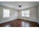 Bedroom featuring hardwood floors, natural light from windows, and a modern ceiling fan at 2137 Delowe Dr, Atlanta, GA 30344