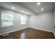 Well-lit bedroom features hardwood floors, recessed lighting, and two large windows at 2137 Delowe Dr, Atlanta, GA 30344