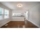 Bright dining area with hardwood floors and a passthrough to the kitchen featuring a view of the front yard at 2137 Delowe Dr, Atlanta, GA 30344