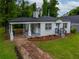 Beautifully landscaped yard of this charming single-story home featuring a covered porch at 2137 Delowe Dr, Atlanta, GA 30344