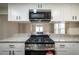 Open kitchen showcasing granite countertops, stainless steel stove, and modern cabinets at 2137 Delowe Dr, Atlanta, GA 30344