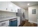 Bright kitchen with stainless steel refrigerator, granite countertops, and white cabinets at 2137 Delowe Dr, Atlanta, GA 30344