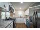 Charming kitchen featuring stainless steel appliances, granite countertops, and modern white cabinetry at 2137 Delowe Dr, Atlanta, GA 30344