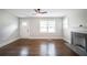 Living room featuring beautiful hardwood floors, a decorative fireplace, and a door to the outside at 2137 Delowe Dr, Atlanta, GA 30344